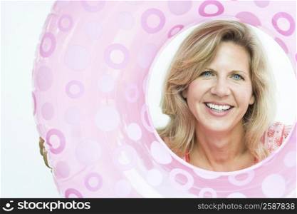 Portrait of a mature woman holding an inflatable ring
