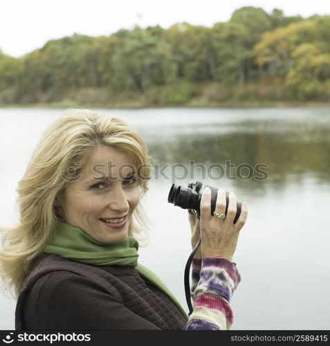 Portrait of a mature woman holding binoculars and smiling