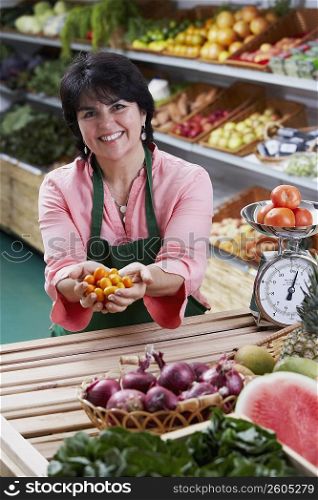 Portrait of a mature woman holding fruits and smiling