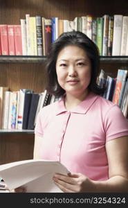 Portrait of a mature woman holding papers