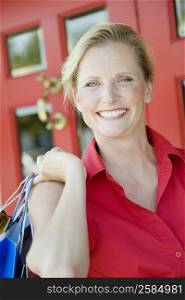 Portrait of a mature woman holding shopping bags and smiling