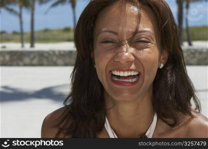 Portrait of a mature woman laughing on the beach, South Beach, Miami Beach, Florida, USA