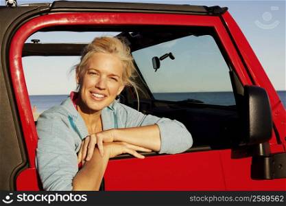 Portrait of a mature woman leaning against the vehicle door
