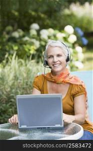 Portrait of a mature woman listening to music with headphones