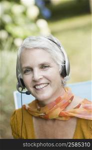 Portrait of a mature woman listening to music with headphones