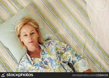 Portrait of a mature woman lying in bed