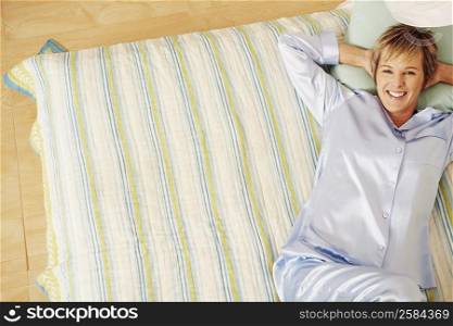Portrait of a mature woman lying in bed and smiling