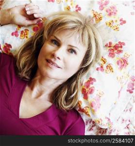 Portrait of a mature woman lying on the bed