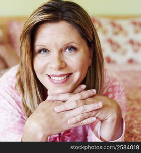 Portrait of a mature woman lying on the bed and smiling