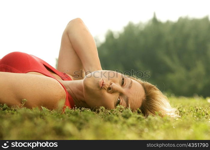 Portrait of a mature woman lying on the grass