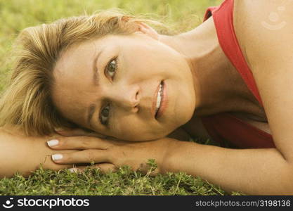 Portrait of a mature woman lying on the lawn