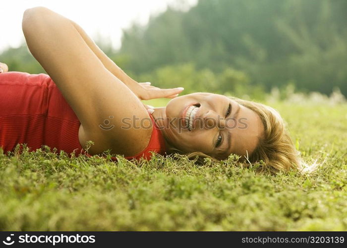 Portrait of a mature woman lying on the lawn