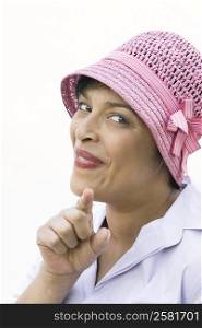 Portrait of a mature woman making a face and pointing forward