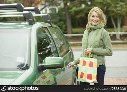 Portrait of a mature woman opening the door of a car