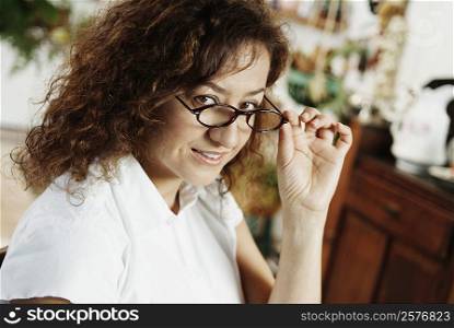 Portrait of a mature woman peeking over her eyeglasses