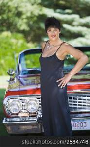 Portrait of a mature woman posing in front of a car