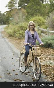 Portrait of a mature woman riding a bicycle and smiling