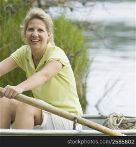 Portrait of a mature woman rowing a boat and smiling