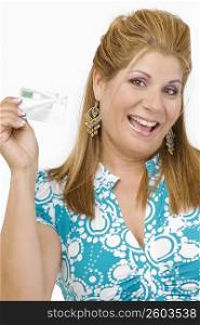 Portrait of a mature woman showing a credit card and smiling
