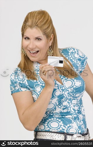 Portrait of a mature woman showing a credit card and smiling