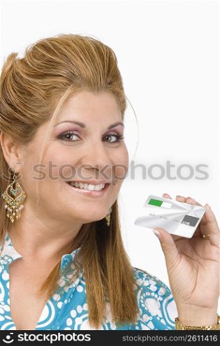 Portrait of a mature woman showing a credit card and smiling