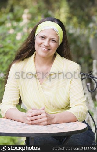 Portrait of a mature woman sitting at a table and smiling