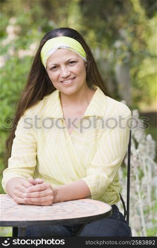 Portrait of a mature woman sitting at a table and smiling
