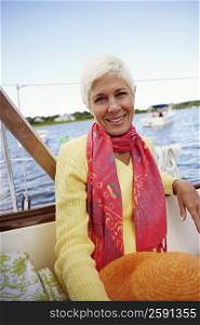 Portrait of a mature woman sitting in a boat and smiling