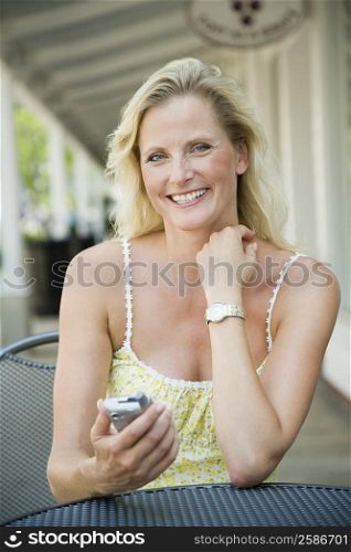 Portrait of a mature woman sitting in a cafe and smiling