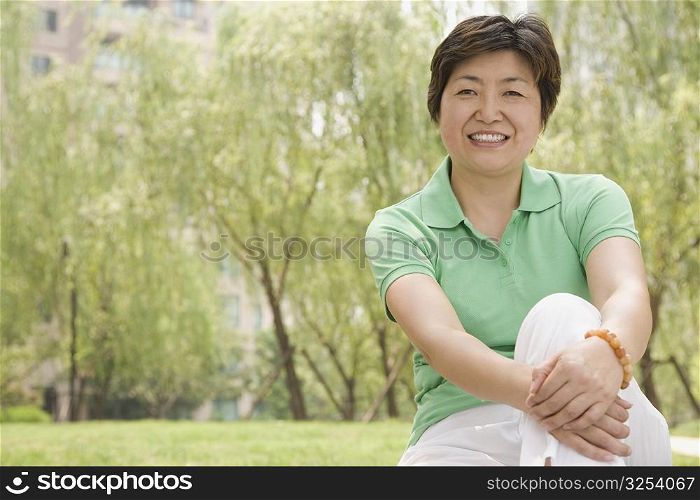 Portrait of a mature woman sitting in a park and smiling