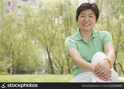 Portrait of a mature woman sitting in a park and smiling
