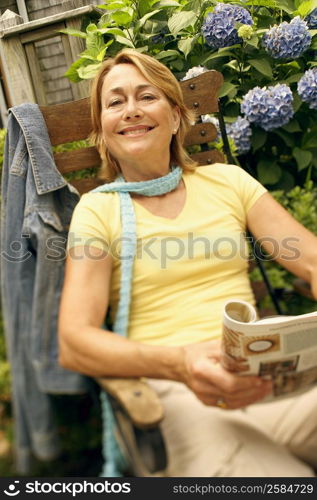 Portrait of a mature woman sitting in an armchair and smiling