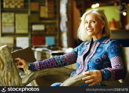 Portrait of a mature woman sitting on a chair and smiling