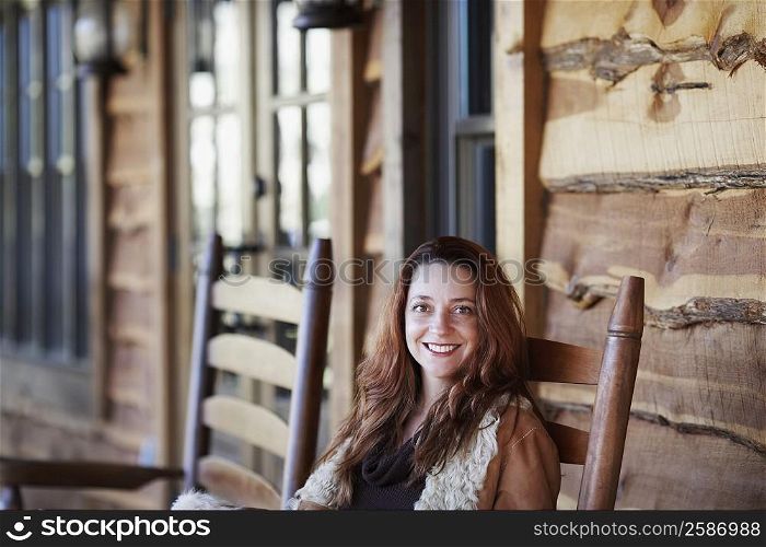 Portrait of a mature woman sitting on a chair and smiling