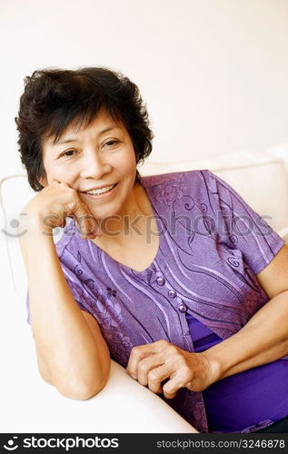 Portrait of a mature woman sitting on a couch