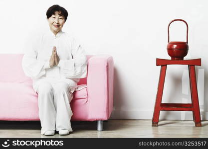 Portrait of a mature woman sitting on a couch