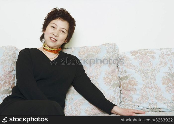 Portrait of a mature woman sitting on a couch