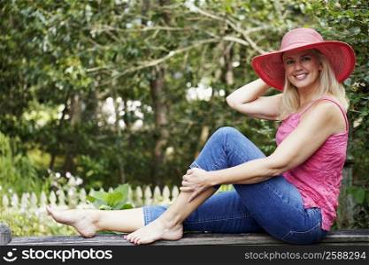 Portrait of a mature woman sitting on a railing