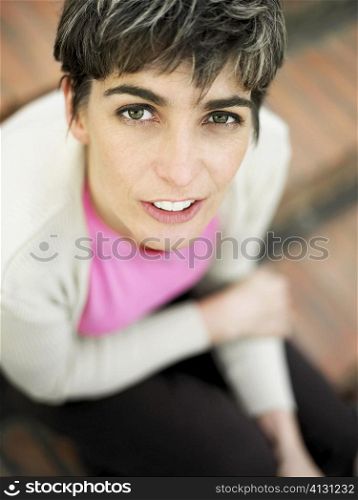 Portrait of a mature woman sitting on steps