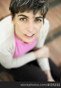 Portrait of a mature woman sitting on steps