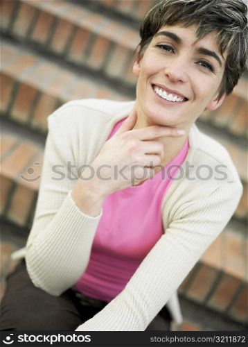 Portrait of a mature woman sitting on steps and smiling