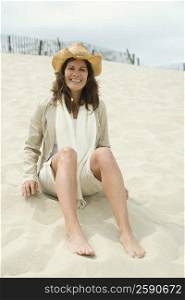 Portrait of a mature woman sitting on the beach and smiling