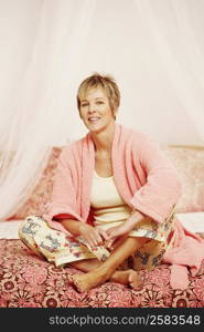 Portrait of a mature woman sitting on the bed