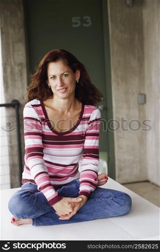 Portrait of a mature woman sitting on the table