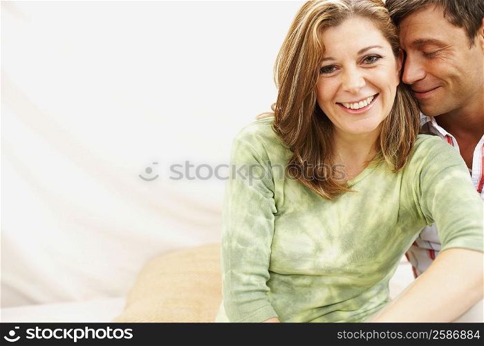 Portrait of a mature woman sitting with a mid adult man and smiling