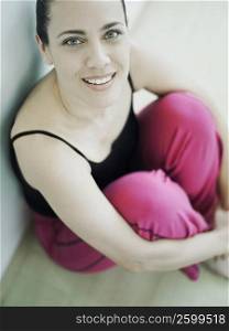Portrait of a mature woman smiling and hugging her knees