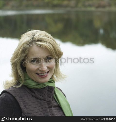 Portrait of a mature woman smiling at the lakeside
