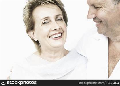 Portrait of a mature woman smiling with a senior man looking at her