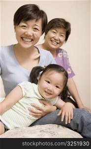 Portrait of a mature woman smiling with her daughter and granddaughter