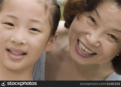 Portrait of a mature woman smiling with her granddaughter
